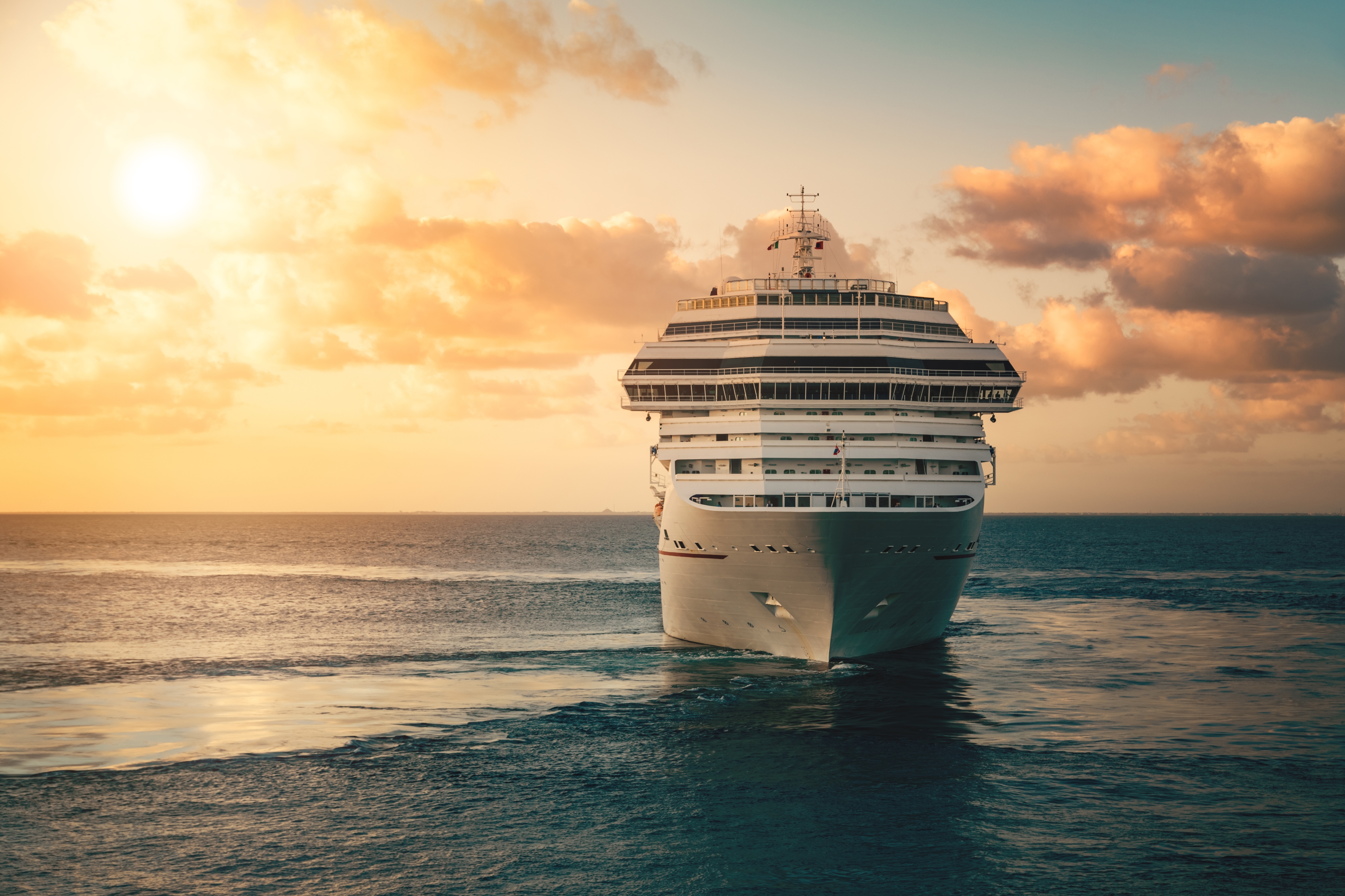 Cruise ship sailing at sunset